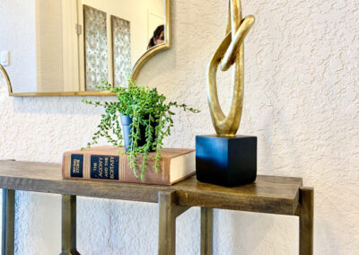 Shelf with book, plant and artwork